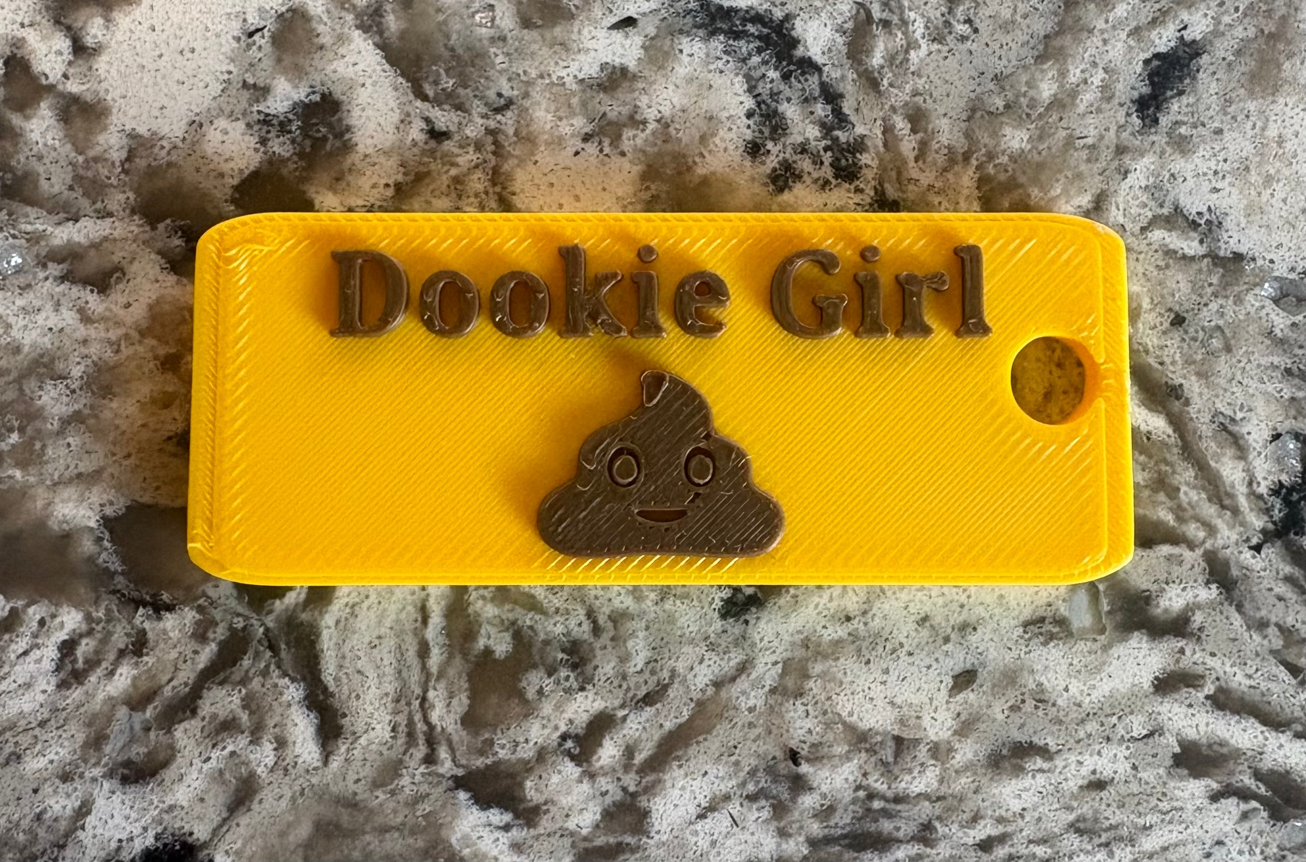 Dookie Girl Keychain - Yellow body with brown lettering, front view