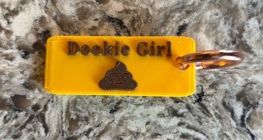 Dookie Girl Keychain - Yellow body with rose gold ring, side view